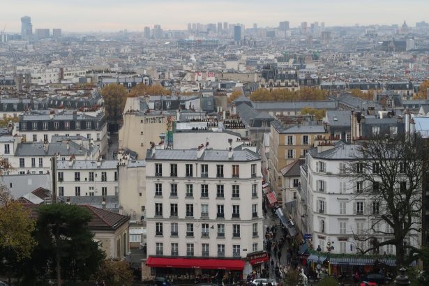 Vista aérea de Montmartre, em Paris, com edifícios históricos e ruas do bairro.